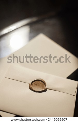 A wax-sealed envelope under soft lighting