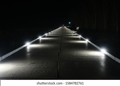the way along the sandy beach in the night with lights at the floor in a small town called Kölpinsee at the baltic sea
