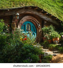 Way around hobbits house overgrown with flowers in a pot with blue doors.This is an Hobbition movie set,Matamata New Zealand 12.01.2021