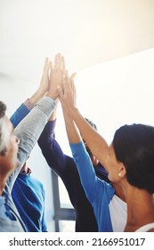 Way To Go, Team. Shot Of A Group Of Businesspeople Giving Each Other A High Five.