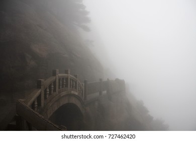The way up on a foggy rainy day, Stone Steep Steps . Treking walking hking Huangshan Mountain. Anhui, China. April 2009