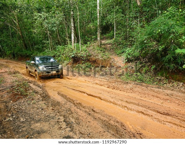 The\
way of red mud in deep jungle for the off road\
truck