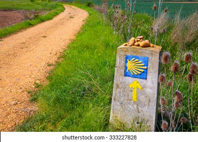 The Way of Saint James shell sign and yellow arrow in Castilla Leon of Spain