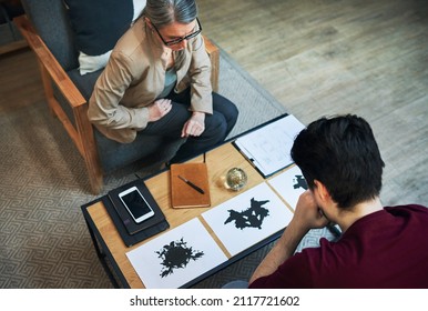 A way to scan the subconscious. Shot of a mature psychologist conducting an inkblot test with her patient during a therapeutic session.