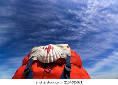 Way of St James , Camino de Santiago ,scallop shell on backpack with blue sky and clouds   to Compostela , Galicia, Spain - Shutterstock ID 2154685021