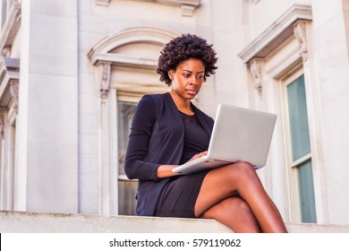 Way To Success. African American Businesswoman Works In New York. Female Black College Student  Sits Outside Vintage Office Building On Campus, Reads, Works On Laptop Computer. Color Filtered Effect