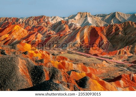 The way through the rainbow Colorful rock formations in the Zhangye Danxia Landform Geological Park. Rainbow mountain in China. Blue sky with copy space