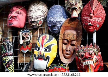 wayang golek and traditional masks on a shelf