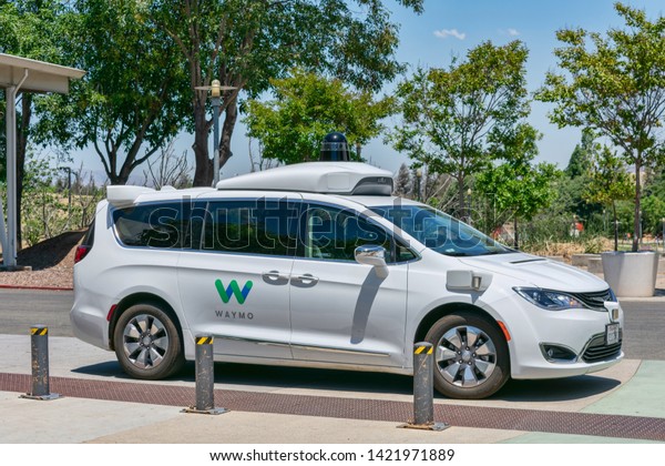 Waymo self driving car performing tests in a parking\
lot near Google\'s headquarters. Waymo is a self-driving technology\
development company - Mountain View,California, USA - June 11,\
2019