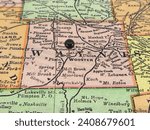 Wayne County, Ohio marked by a black tack on a colorful vintage map. The county seat is located in the city of Wooster, OH.