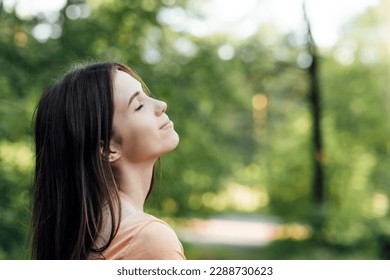 Ways To Unplug From Technology and Be Present. Unplugging from Technology and Living a More Mindful Life. Outdoor portrait of young woman enjoying nature