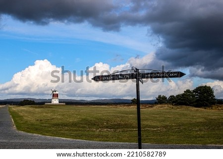 wayside cross with mill and clouds