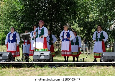 Wdzydze Kiszewskie, Poland - circa July 2022: Performances Kociewie Folk Group on festival. Women stand and sing.