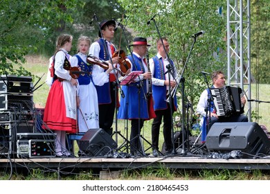 Wdzydze Kiszewskie, Poland - circa July 2022: Performances Kashubian Folk Group "Krëbane" from Brusy village in Kashubia. They play traditional instruments - violin, trumpet, accordion