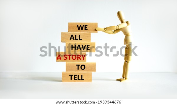 We all have a story to tell symbol. Wooden blocks\
with words \'We all have a story to tell\'. Businessman model.\
Beautiful white background. Business, popular quotation concept.\
Copy space.