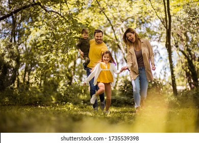 We always enjoy family bonding time. Parents spending time with their children outside. Focus is on foreground. - Shutterstock ID 1735539398