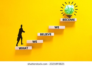 We become or believe symbol. Concept word What we believe We become on wooden block. Beautiful yellow table yellow background. Businessman icon. Business we become or believe concept. Copy space.