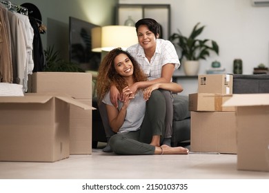 We both pitch in. Shot of a couple unpacking boxes in their new home. - Powered by Shutterstock