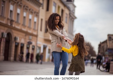 We Came Outside For A Day Of Fun. African American Mother Playing With Her Daughter In The City.