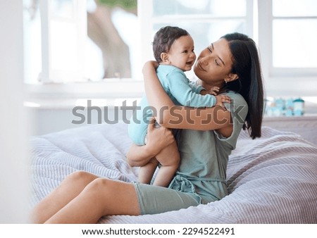 We can do cuddles all day. Shot of a mother bonding with her baby at home.