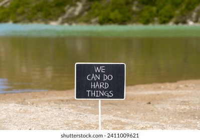 We can do hard things symbol. Concept words We can do hard things on beautiful blackboard. Beautiful mountain lake background. Business, motivation we can do hard things concept. Copy space.