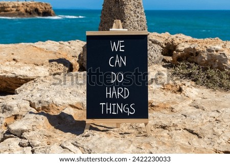 We can do hard things symbol. Concept words We can do hard things on beautiful blackboard. Beautiful stone sea background. Business, we can do hard things concept. Copy space.