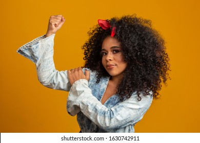 We Can Do It. Woman's Fist Of Female Power. Woman Victim Of Racism. Abuse At Work. The Feminine Power. Female Empowerment. The Strength Of Women. Yellow Background.