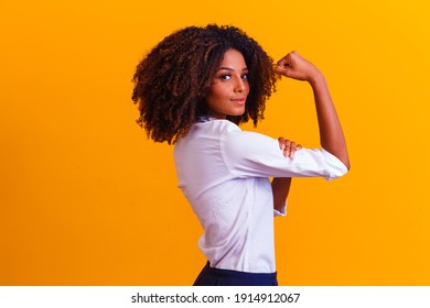 We can do it. Woman's fist of female power. Woman victim of racism. Abuse at work. The feminine power. Female empowerment. The strength of women. Yellow background.
