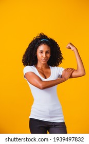 We Can Do It. Woman's Fist Of Female Power. Woman Victim Of Racism. Abuse At Work. The Feminine Power. Female Empowerment. The Strength Of Women. Yellow Background.