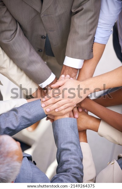 We can do this. Shot of a group of coworkers with\
their hands in a huddle.