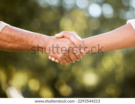 We can do this together. Shot of two unrecognisable men shaking hands outdoors.