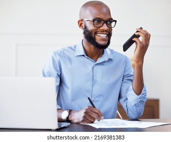 We can meet up and discuss the details. Shot of a businessman doing paperwork and using his cellphone while sitting at his desk. - Shutterstock ID 2169381383
