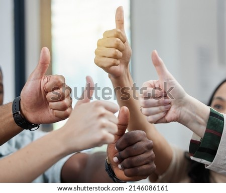 we commend your efforts. Closeup shot of a group of unrecognisable businesspeople showing thumbs up.