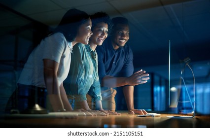 We get what we give our time to. Shot of a group of young businesspeople using a computer together during a late night at work. - Powered by Shutterstock