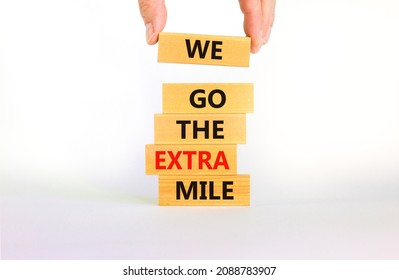 We go the extra mile symbol. Wooden blocks with words We go the extra mile. Beautiful white background, copy space. Businessman hand. Business, we go the extra mile concept. - Shutterstock ID 2088783907
