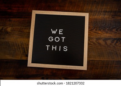 We Got This Message on Board Centered over wooden background