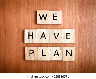 We have Plan text on tiles over wooden background