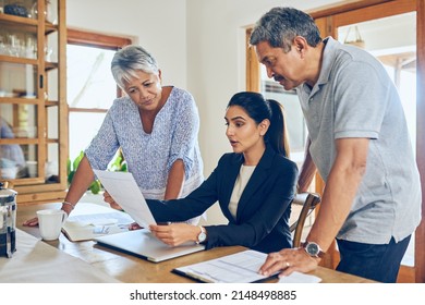 We Have A Range Of Retirement Portfolios On Offer. Shot Of A Mature Couple Getting Advice From Their Financial Consultant At Home.