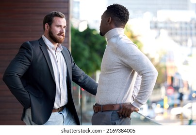 We Have Some Important Decisions To Make. Shot Of Two Co Workers Having A Conversation On Their Office Balcony.