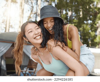 We havent done this in ages. Shot of an attractive young woman giving her friend a piggyback ride during a day in the woods. - Powered by Shutterstock