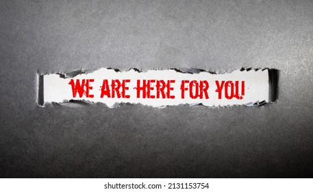 We are here to help, is written on a notepad, on an office desk with office accessories. - Shutterstock ID 2131153754
