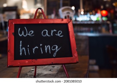 We Are Hiring Sign On Chalkboard  In A Restaurant