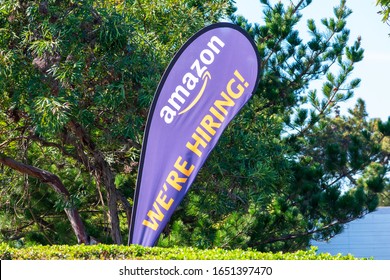 We Are Hiring. Text On Feather Flag Banner Advertising Hiring By Amazon. Amazon.com Is Hiring New Workers To Meet Demand During Coronavirus Outbreak - Sunnyvale, CA, USA - 2020