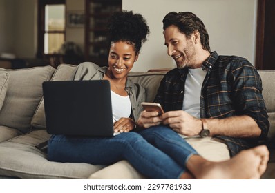 We just share a special connection between us. a happy young couple using a laptop and cellphone while relaxing on a couch home. - Powered by Shutterstock