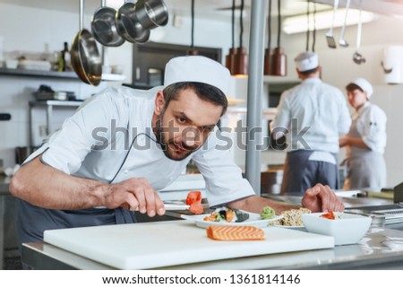 We know how to cook. Chef cook preparing japanese food in modern commerical kitchen