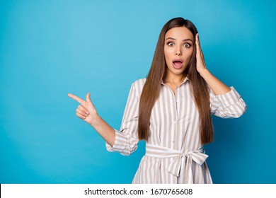 We are late. Photo of pretty attractive manager lady direct finger side empty space show high shopping prices open mouth wear striped casual dress isolated blue color background