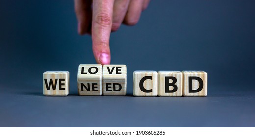 We love CBD, cannabidiol symbol. Hand turns cubes and changes words 'We need CBD' to 'We love CBD'. Beautiful grey background, copy space. Medical and we love CBD cannabidiol concept.