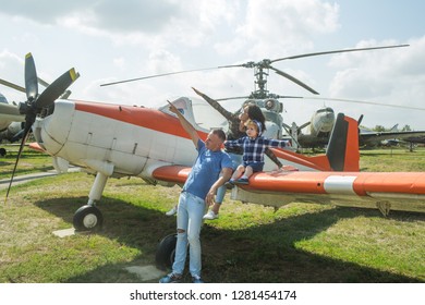 We Love To Fly. Family Couple With Son On Vacation Travel. Woman And Man With Boy Child At Helicopter. Happy Family Vacation. Air Tour And Travel. Enjoying Travelling By Air.