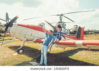 We Love To Fly. Family Couple With Son On Vacation Travel. Woman And Man With Boy Child At Helicopter. Happy Family Vacation. Air Tour And Travel. Enjoying Travelling By Air.