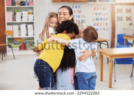 We love our teacher. Shot of a woman hugging her learners.